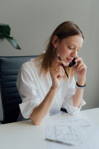 Female in an office working on paper to place a ups system